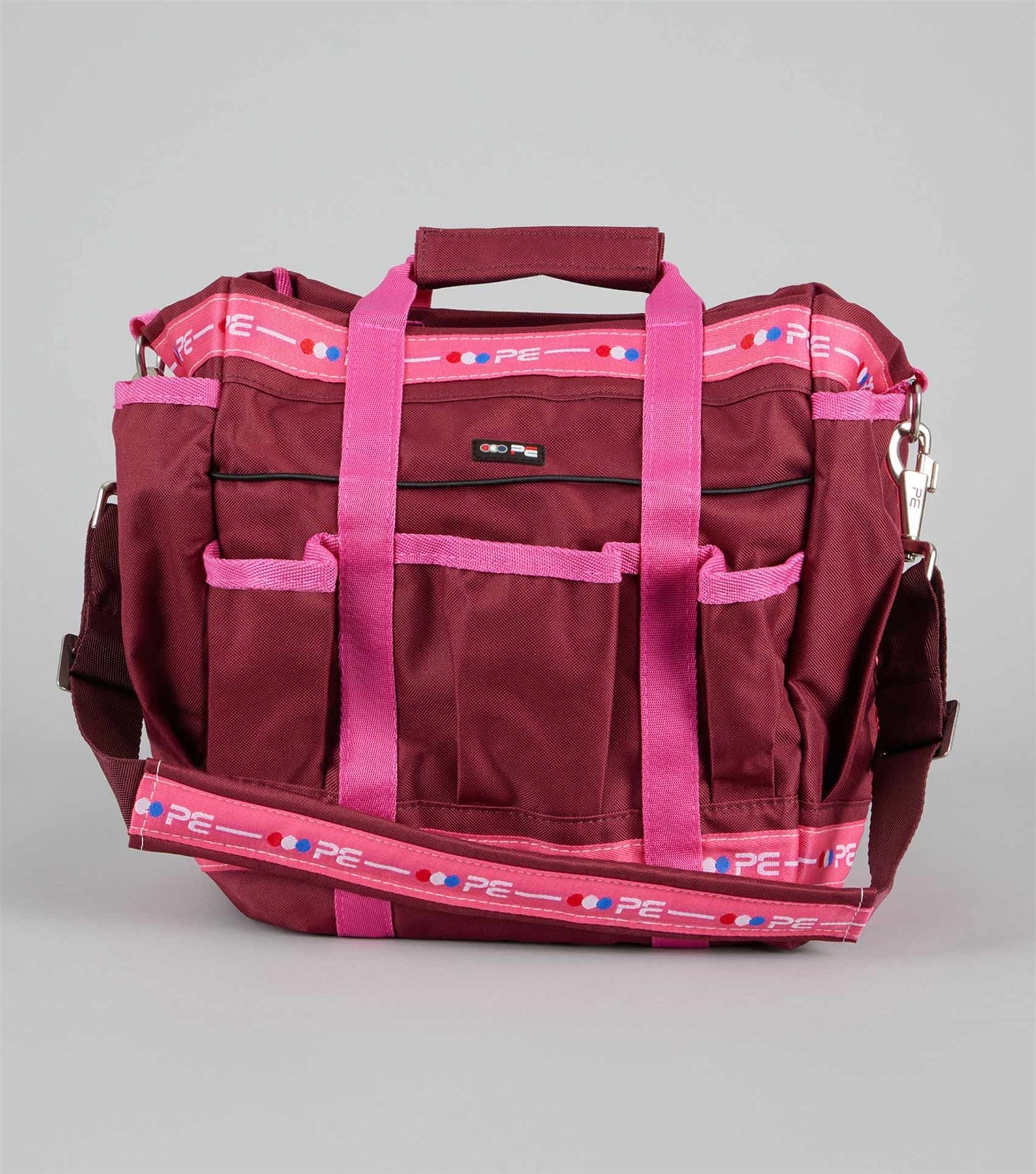 Burgundy and pink canvas horse grooming kit bag with brush pockets and shoulder strap