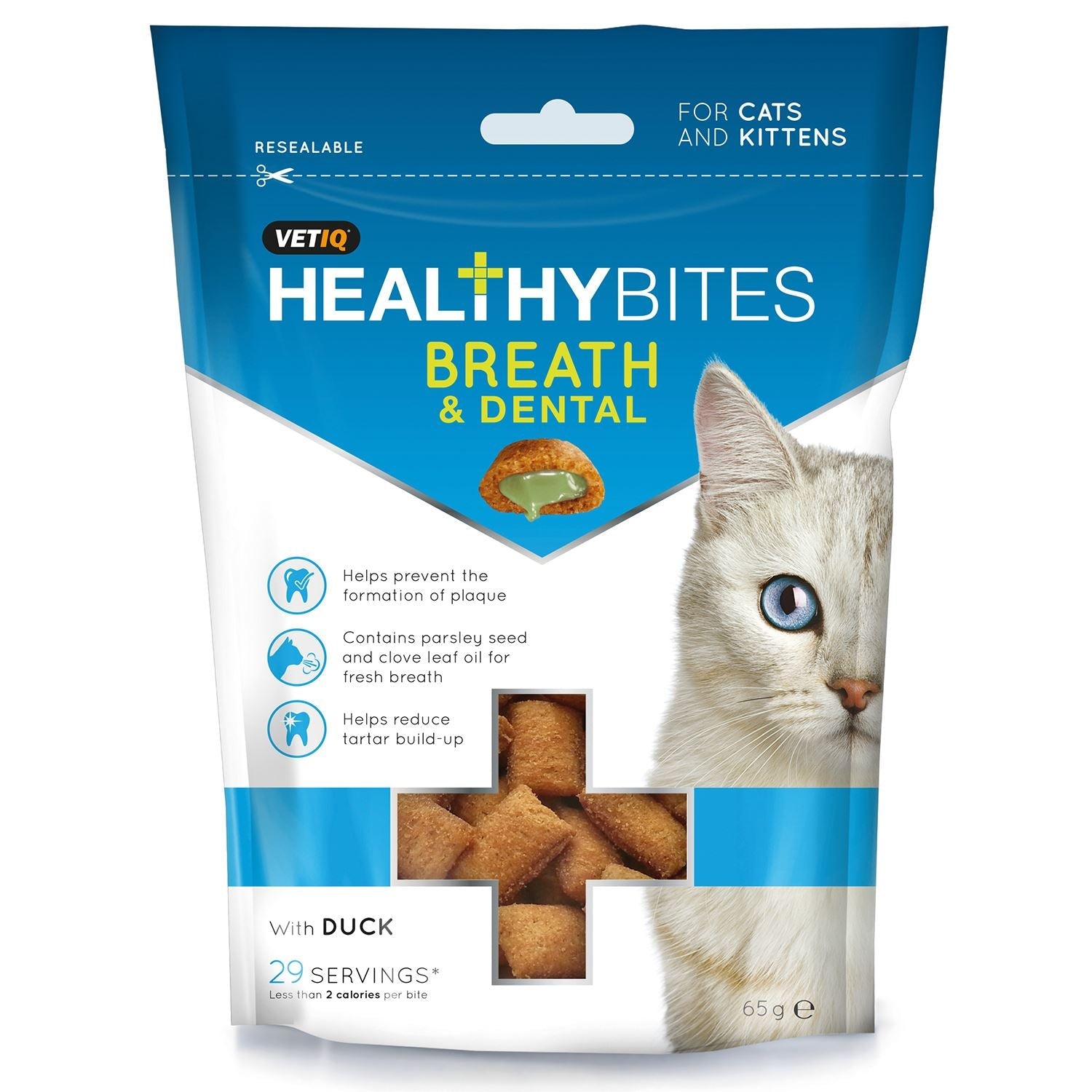 White cat beside a blue pack of dental care treats for cats and kittens
