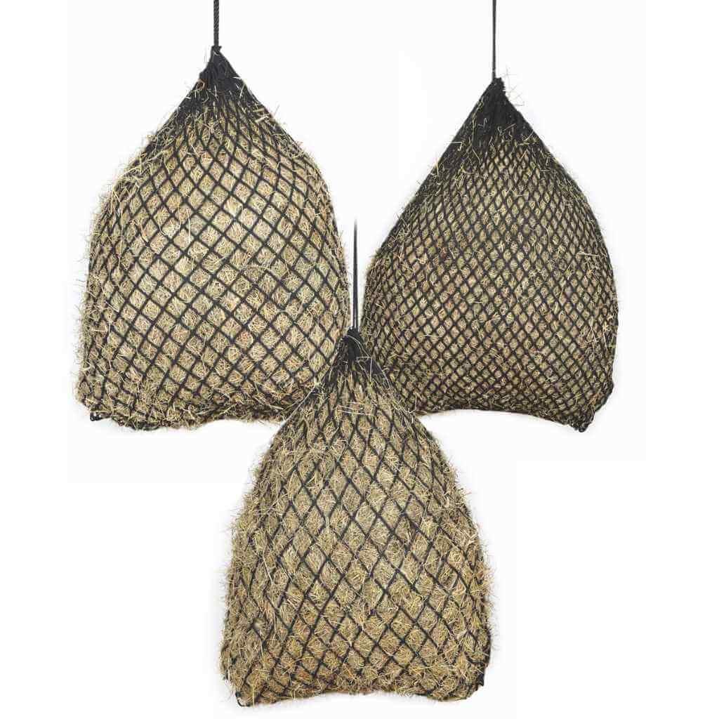 Three black soft-mesh haynets filled with hay, hanging side by side