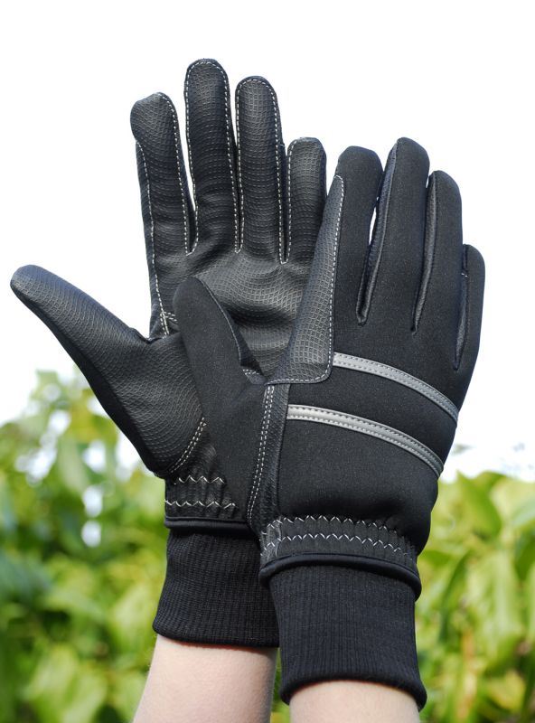 Pair of black padded winter riding gloves with reflective strips worn on raised hands outdoors
