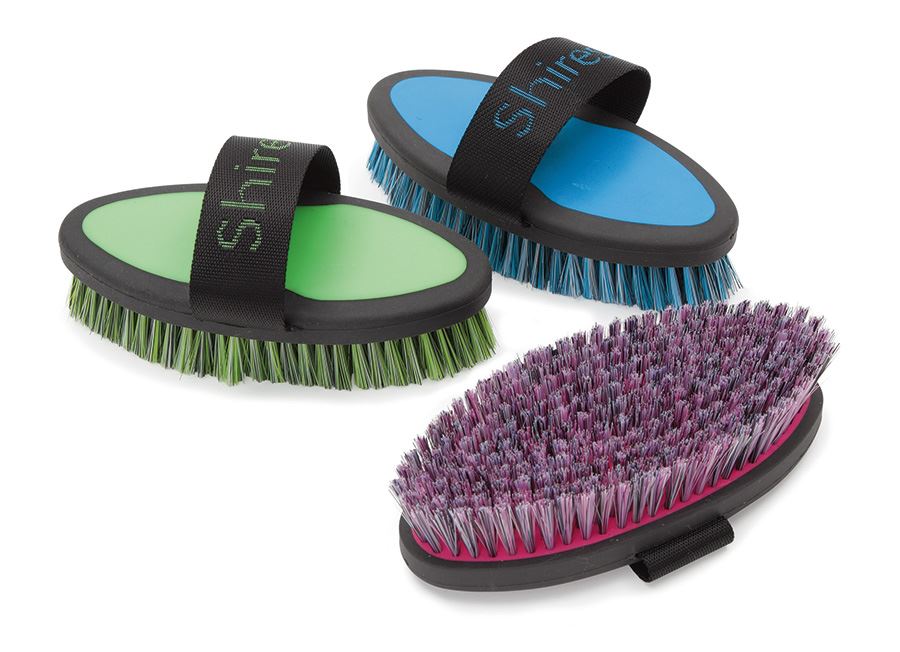 Three coloured horse grooming body brushes with hand straps in green, blue and pink
