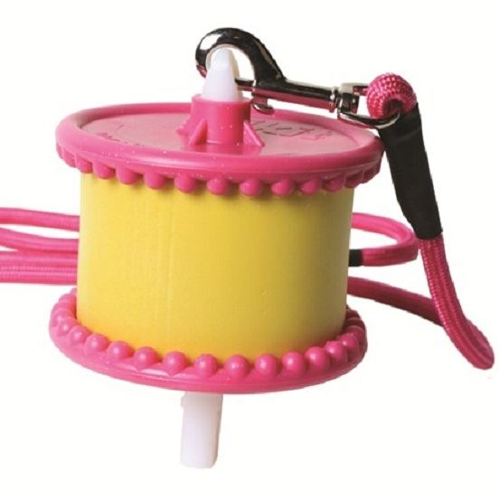 Pink hanging stable lick holder with a yellow treat block and rope